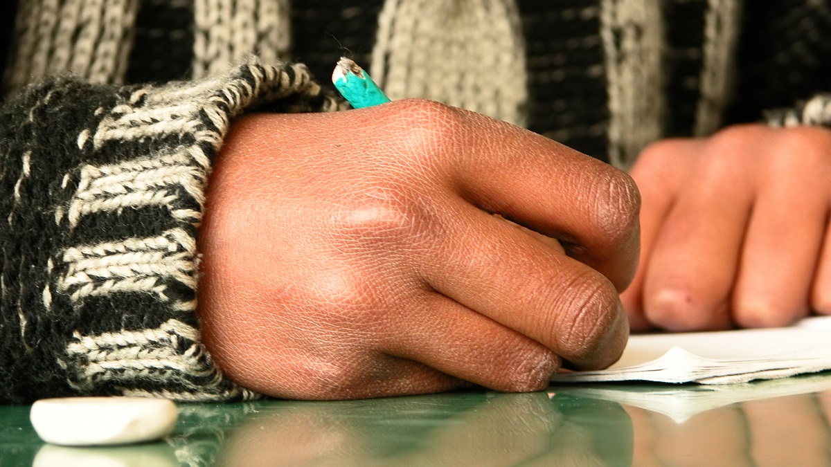 Close up of chewed pencil in the hand of a student