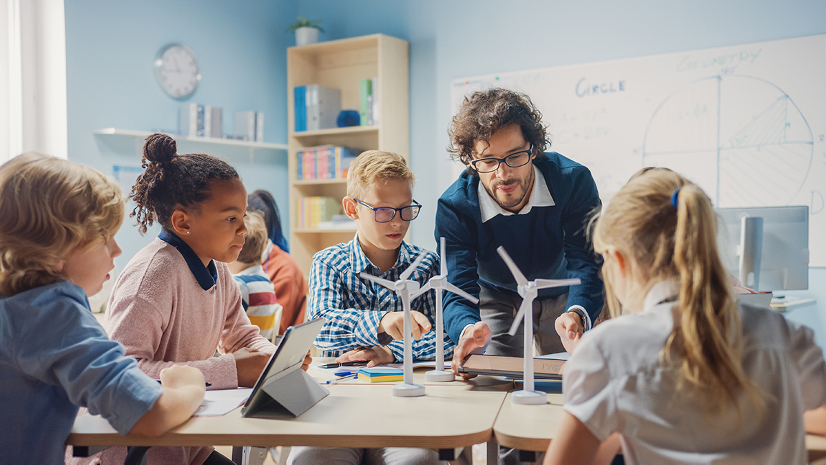 Children in classroom with teacher learning about renewable energy