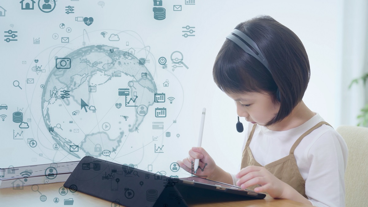 Young girl wearing computer headset plays on a tablet device - graphic world map hovering above