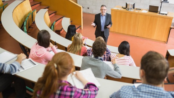 University teacher with students sitting in a lecture hall